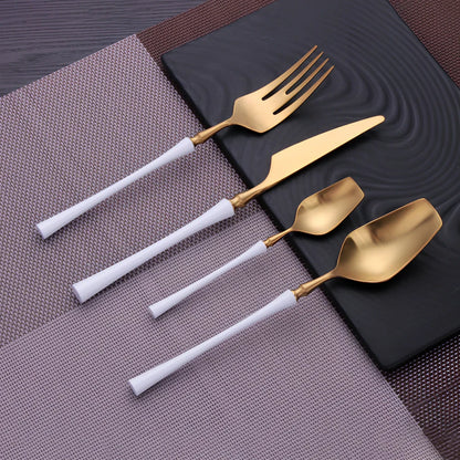 Four-piece stainless steel cutlery set showing main knife, fork, spoon, and teaspoon with mirror finish