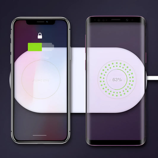 White dual wireless fast charging pad for two mobile phones on a wooden desk.