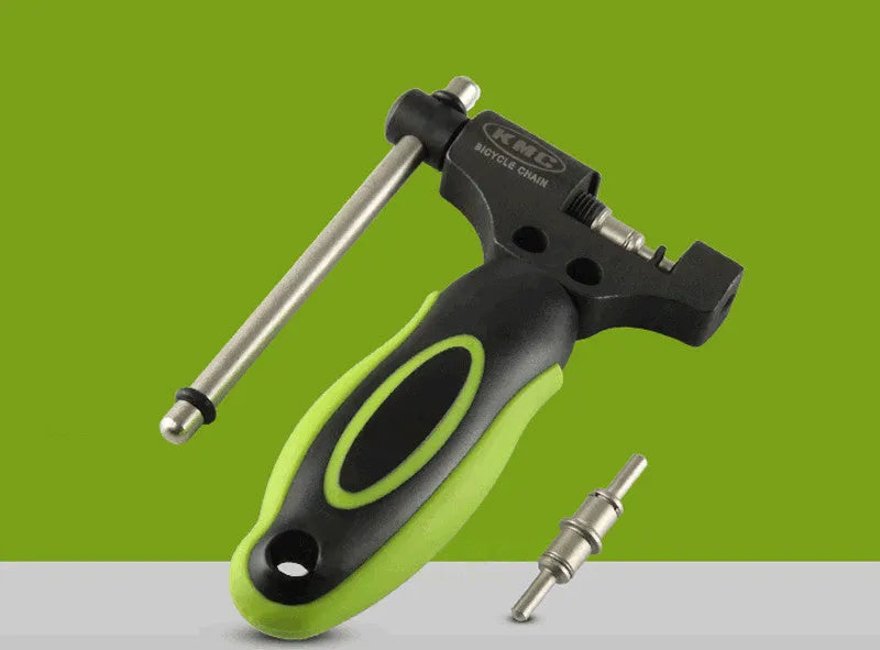 Green-handled steel bicycle chain tool with a double shaft chaining device on a white background.