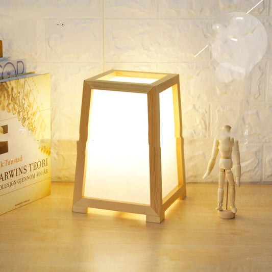 Bamboo wood table lamp with square base and dimmable LED lighting on wooden surface