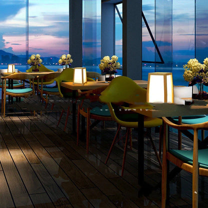 Bamboo wood table lamp with square base and dimmable LED lighting on wooden surface