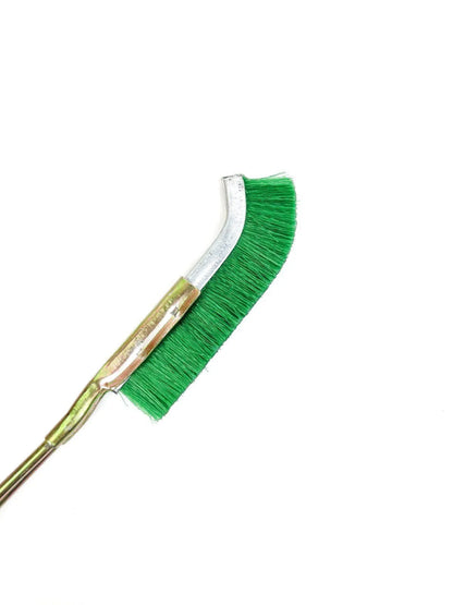 Green elbow-shaped nylon wire brush with metal handle for rust removal and appliance cleaning