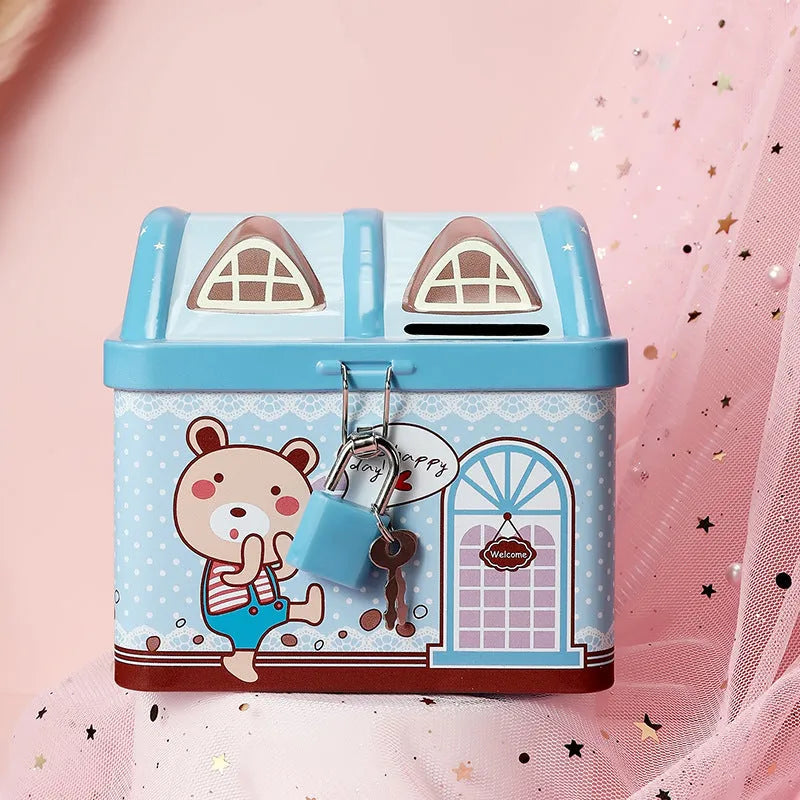 Blue house shaped tinplate piggy bank on desktop with coin slot