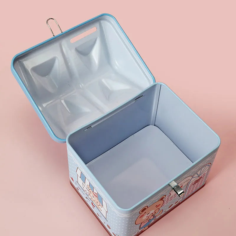 Blue house shaped tinplate piggy bank on desktop with coin slot