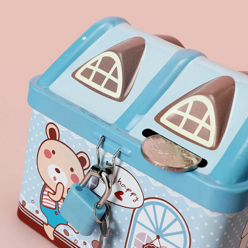 Blue house shaped tinplate piggy bank on desktop with coin slot