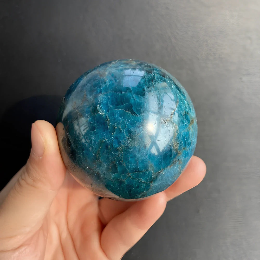 Natural blue apatite crystal ball showing spherical form with genuine mineral texture and colour variations