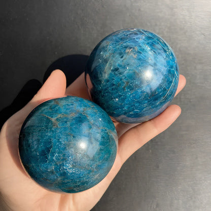 Natural blue apatite crystal ball showing spherical form with genuine mineral texture and colour variations