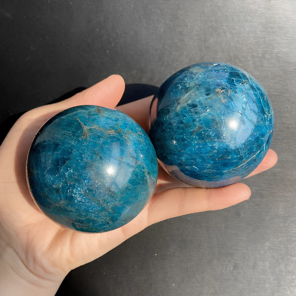 Natural blue apatite crystal ball showing spherical form with genuine mineral texture and colour variations