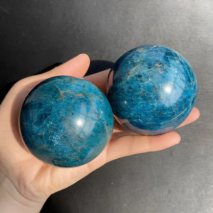 Natural blue apatite crystal ball showing spherical form with genuine mineral texture and colour variations