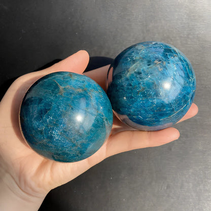 Natural blue apatite crystal ball showing spherical form with genuine mineral texture and colour variations