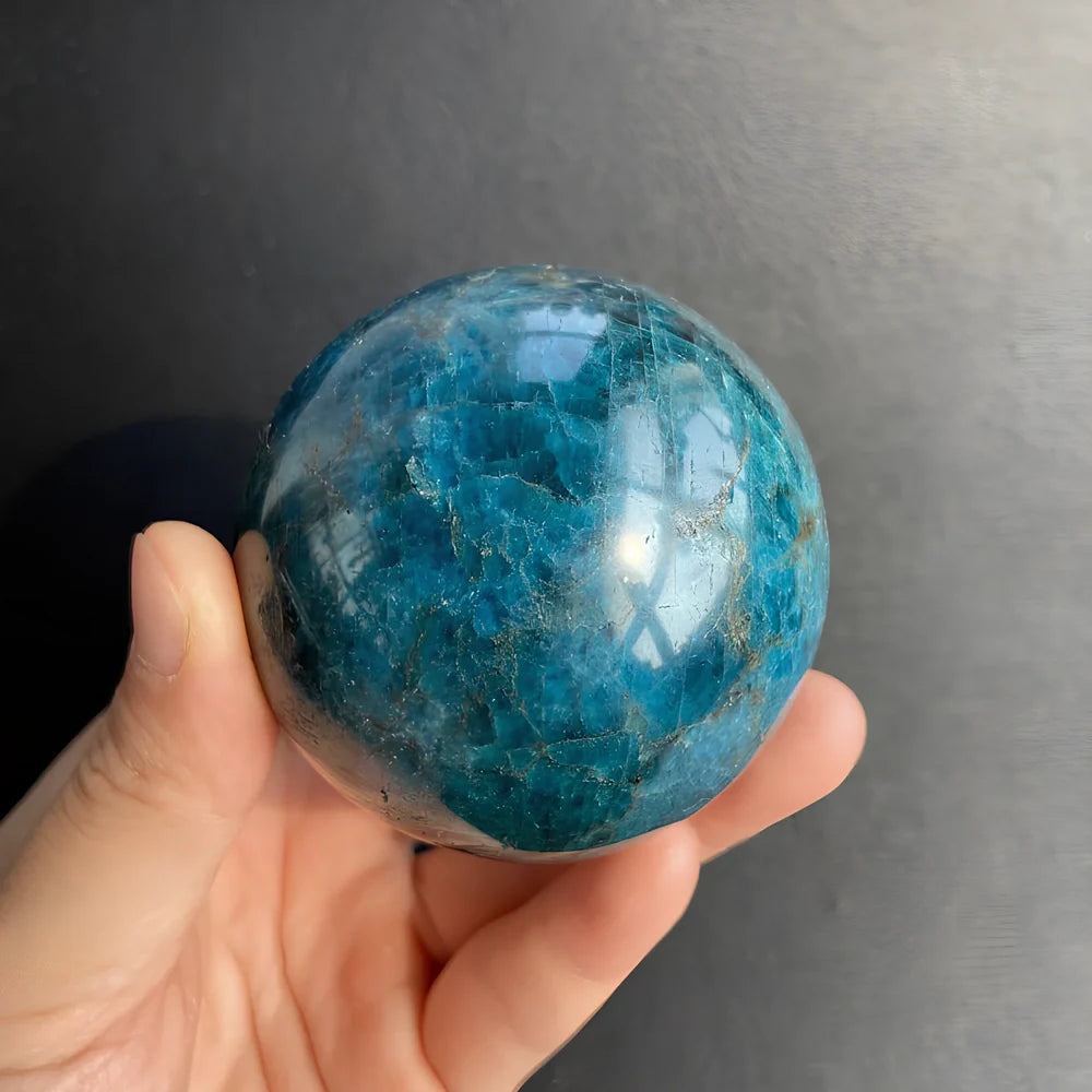 Natural blue apatite crystal ball showing spherical form with genuine mineral texture and colour variations