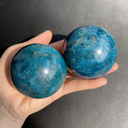Natural blue apatite crystal ball showing spherical form with genuine mineral texture and colour variations