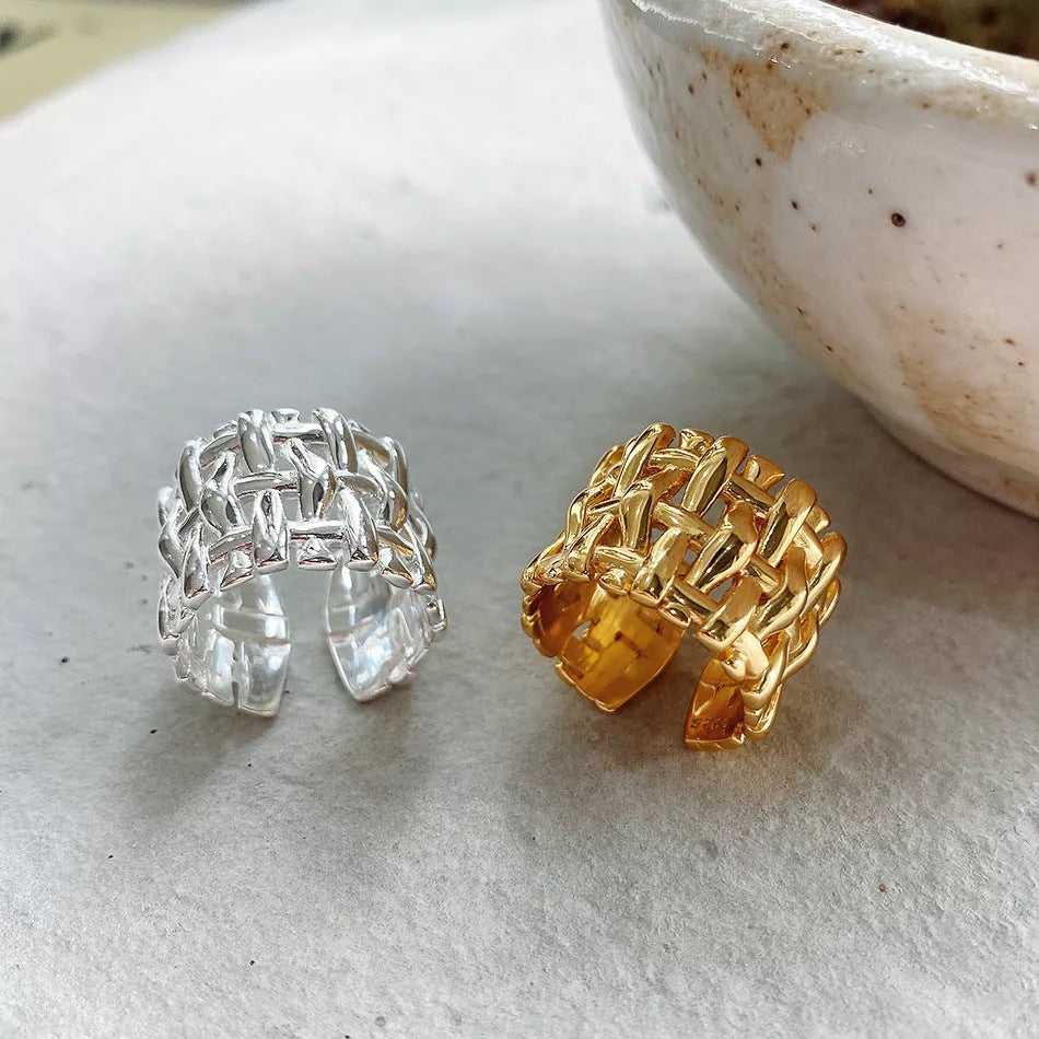 Woven brass ring with hollow cross design for women, available in gold and silver.