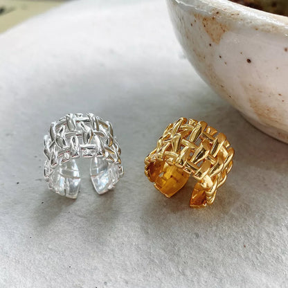 Woven brass ring with hollow cross design for women, available in gold and silver.