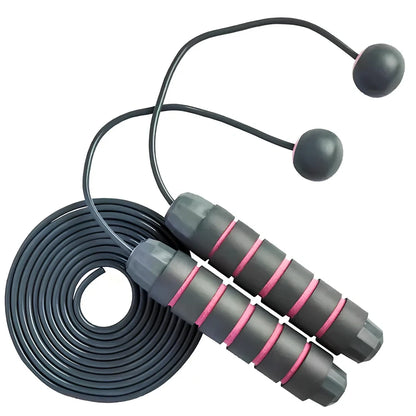 Pink and grey skipping rope with weighted handles and adjustable length mechanism for fitness training