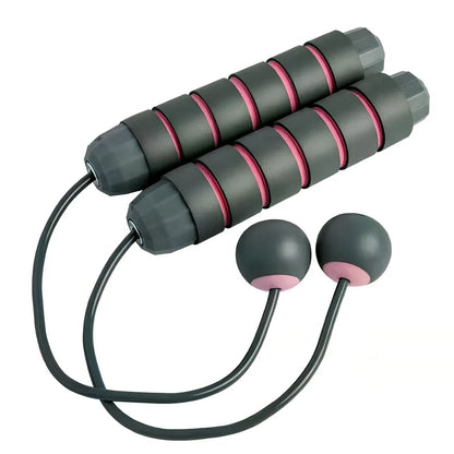 Pink and grey skipping rope with weighted handles and adjustable length mechanism for fitness training