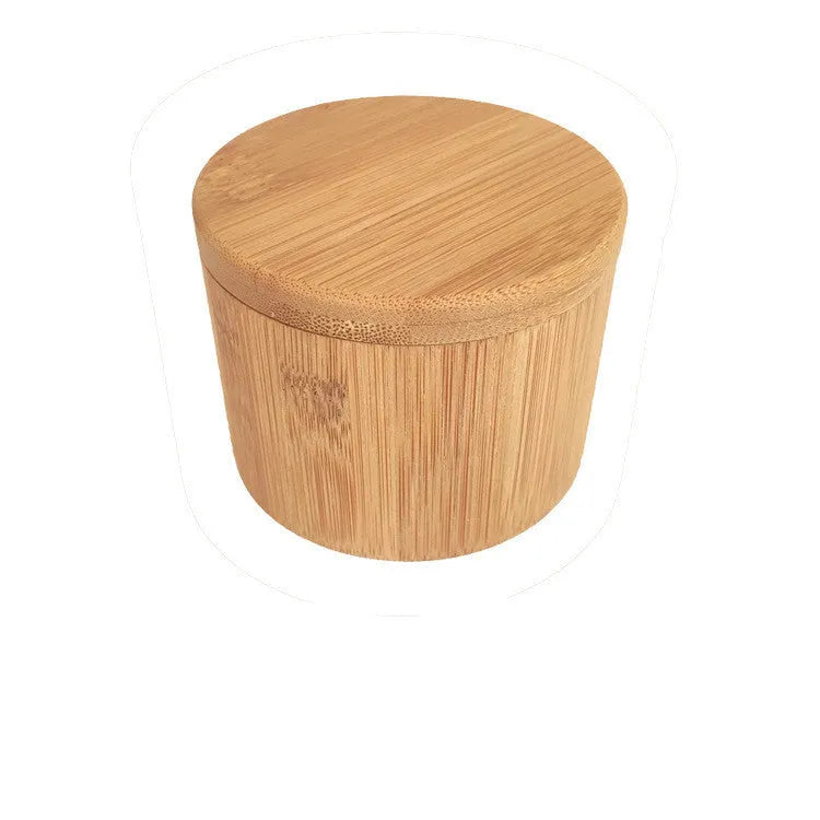 Bamboo seasoning box and spoon set for solid spices on a kitchen counter.