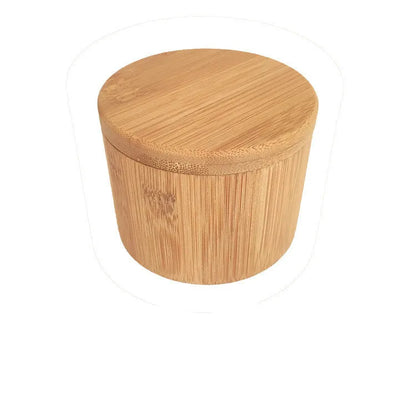 Bamboo seasoning box and spoon set for solid spices on a kitchen counter.
