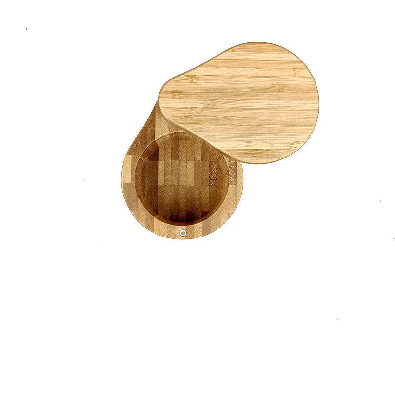 Bamboo seasoning box and spoon set for solid spices on a kitchen counter.