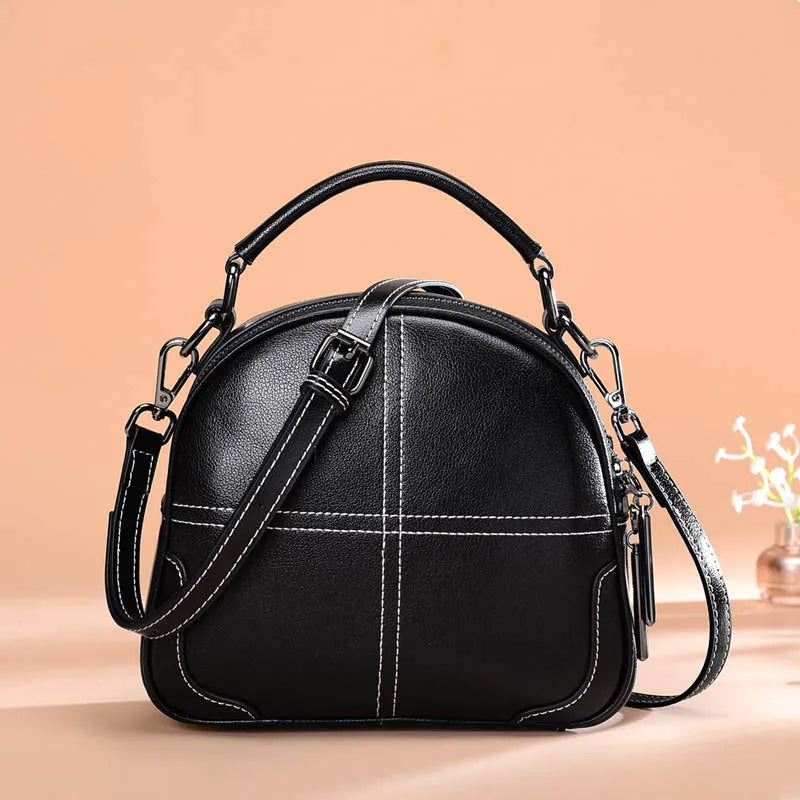 Round leather handbag in wine red with soft handle, measuring 21cm wide and 18.5cm high, featuring a zipper opening.