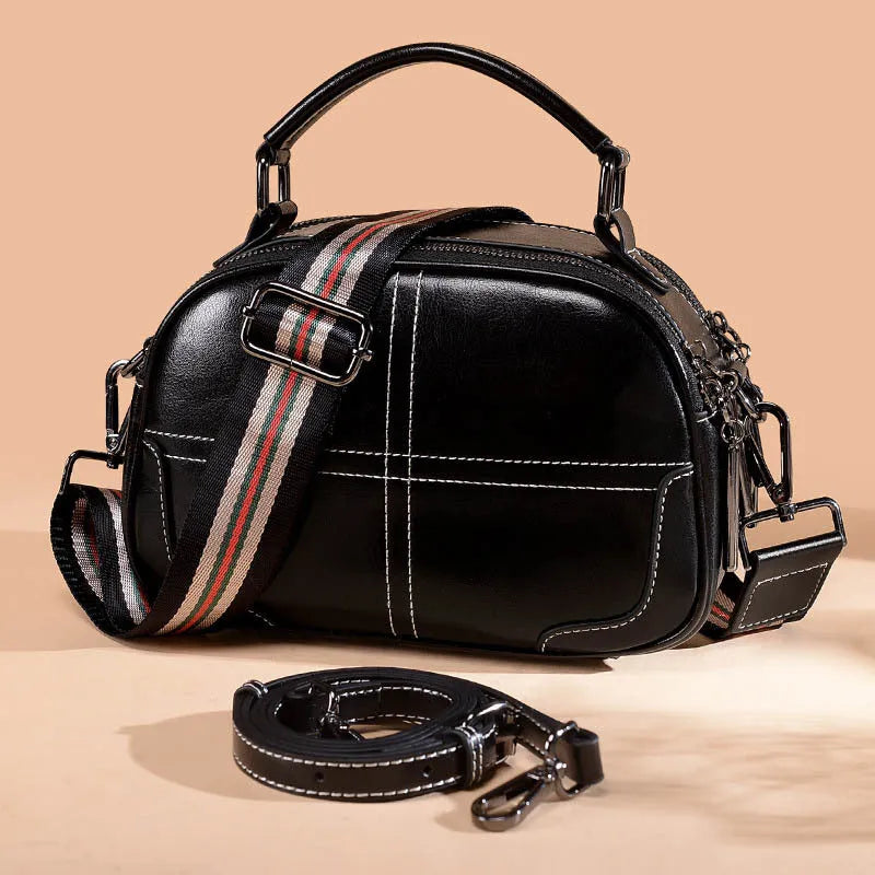 Round leather handbag in wine red with soft handle, measuring 21cm wide and 18.5cm high, featuring a zipper opening.