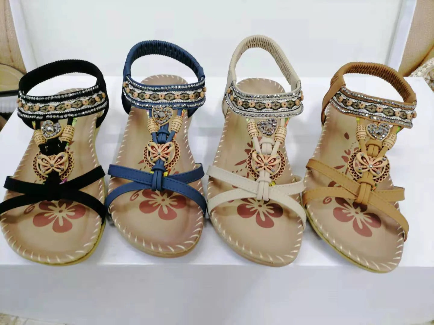 Fashionable floral rhinestone sandals with a durable rubber sole and supple PU upper for comfortable style.
