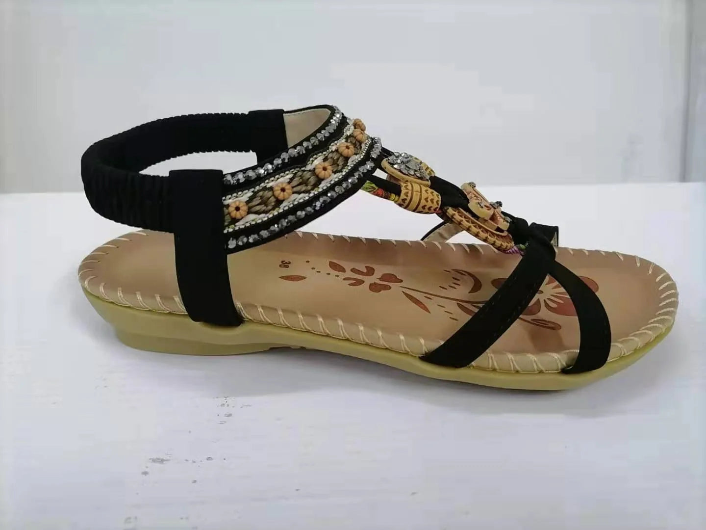 Fashionable floral rhinestone sandals with a durable rubber sole and supple PU upper for comfortable style.