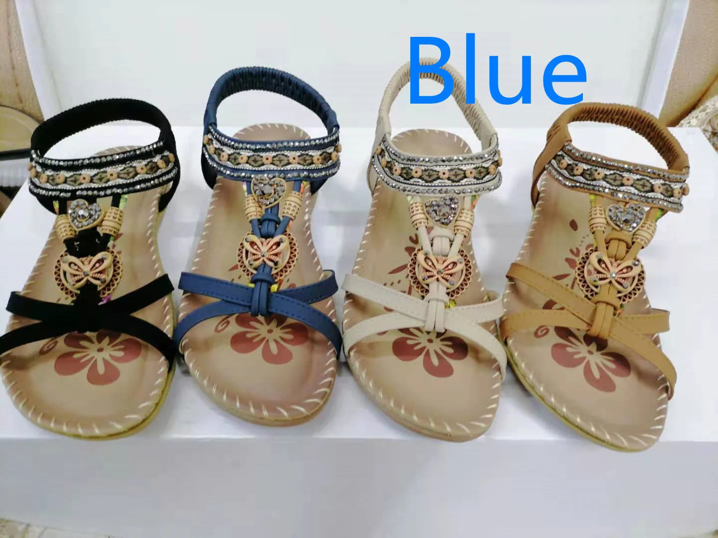 Fashionable floral rhinestone sandals with a durable rubber sole and supple PU upper for comfortable style.