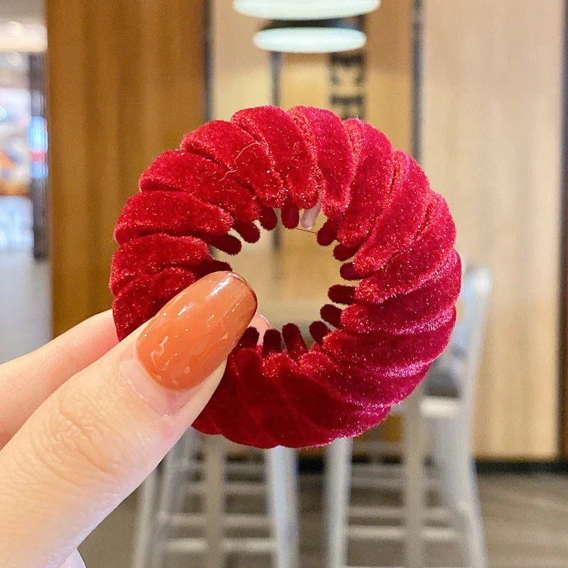 Adjustable ponytail hair accessory with flexible teeth, available in various colors, designed for easy, natural-looking hairstyles