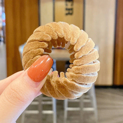 Adjustable ponytail hair accessory with flexible teeth, available in various colors, designed for easy, natural-looking hairstyles
