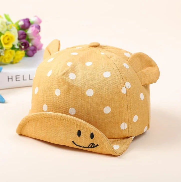 Baby wearing navy blue baseball cap with short brim, dome top design for children 6-24 months