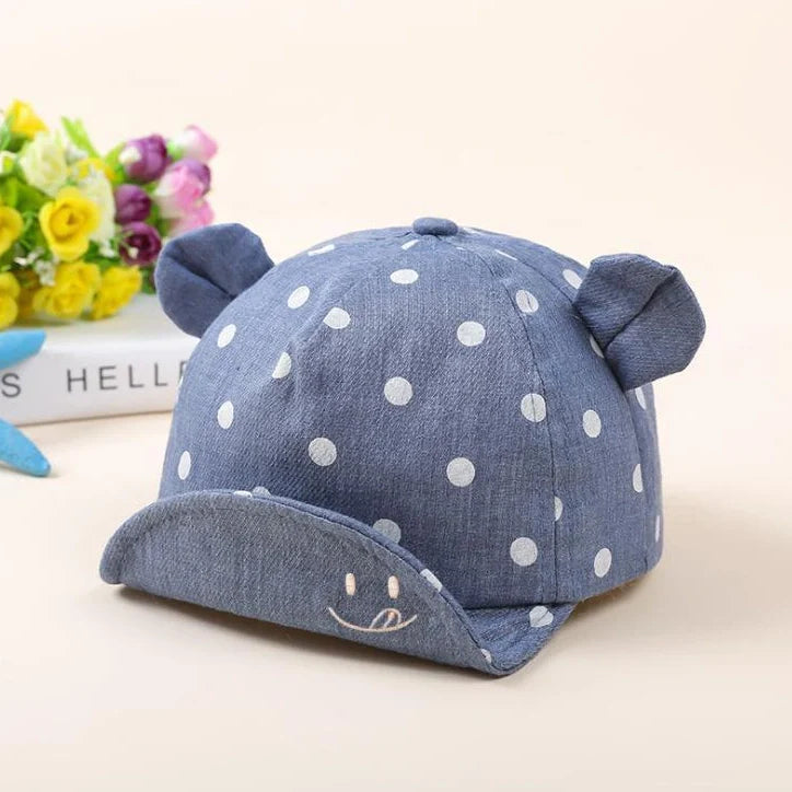 Baby wearing navy blue baseball cap with short brim, dome top design for children 6-24 months