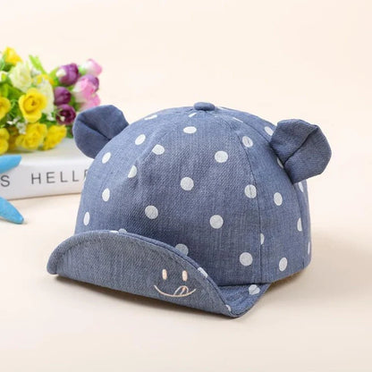 Baby wearing navy blue baseball cap with short brim, dome top design for children 6-24 months