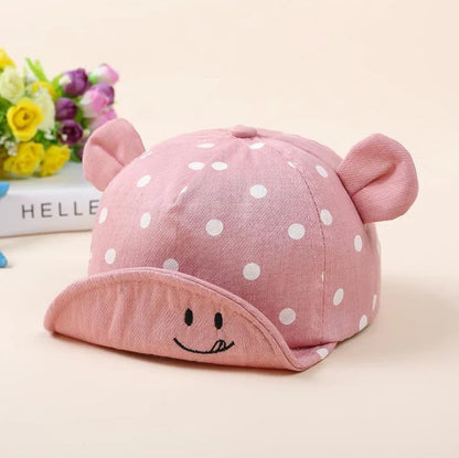 Baby wearing navy blue baseball cap with short brim, dome top design for children 6-24 months