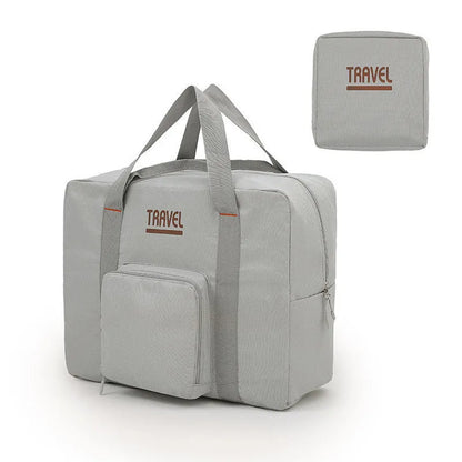 Cube-shaped travel bag with compression seal in Oxford cloth, shown in khaki colour with clothing items inside