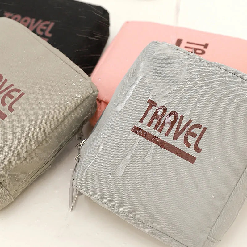 Cube-shaped travel bag with compression seal in Oxford cloth, shown in khaki colour with clothing items inside