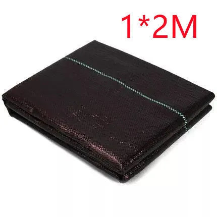 Black composite woven PE weed prevention cloth laid flat on soil.