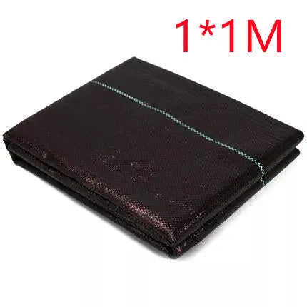 Black composite woven PE weed prevention cloth laid flat on soil.