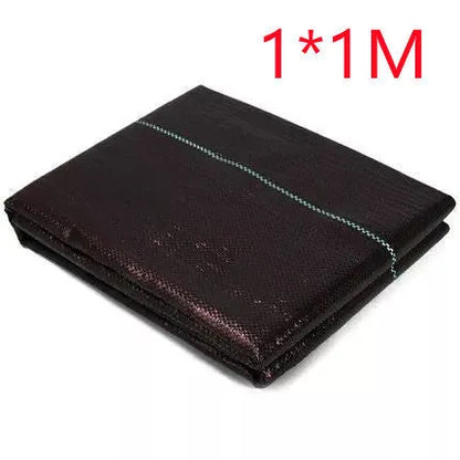 Black composite woven PE weed prevention cloth laid flat on soil.