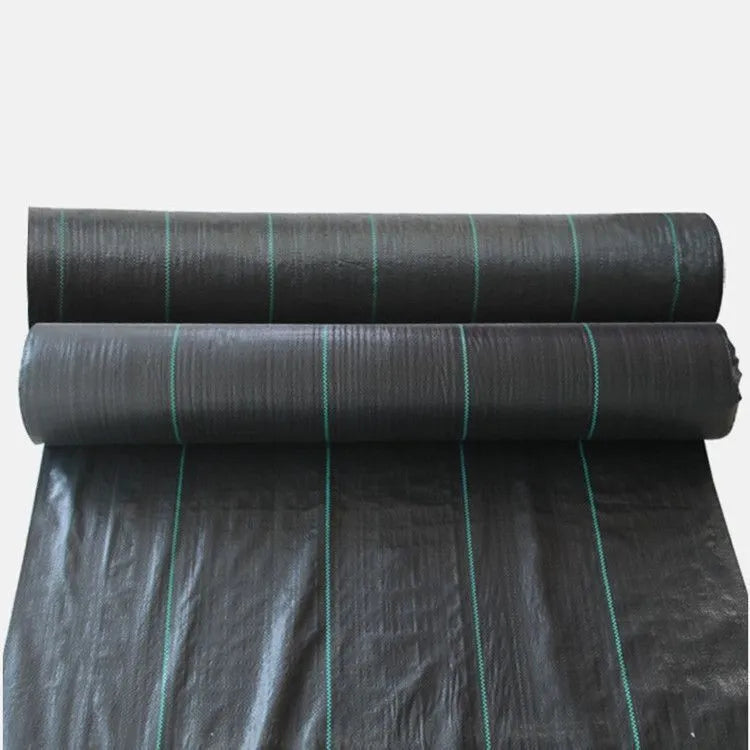 Black composite woven PE weed prevention cloth laid flat on soil.