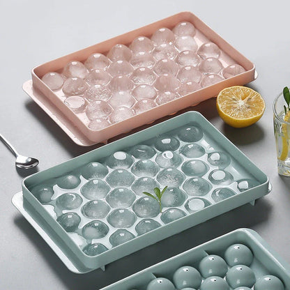 Premium 3D round ice cube trays in pink and green colors for chilling drinks and making frozen treats