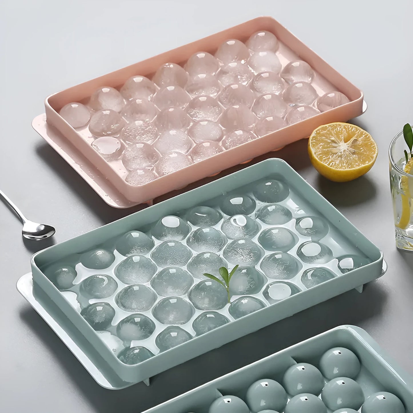 3D round ice moulds in sky blue or pink colours showing 18 and 33 grid options