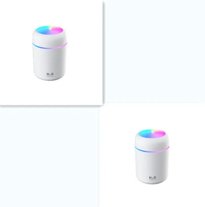 Pink car air purifying humidifier with LED lights on, next to a USB cable.