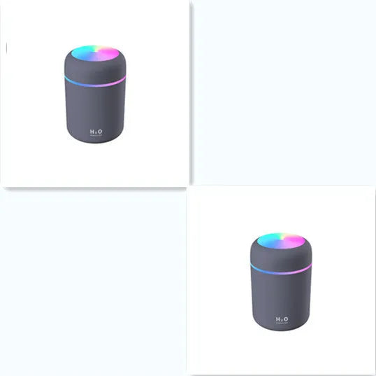 Pink car air purifying humidifier with LED lights on, next to a USB cable.
