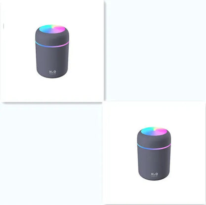 Pink car air purifying humidifier with LED lights on, next to a USB cable.