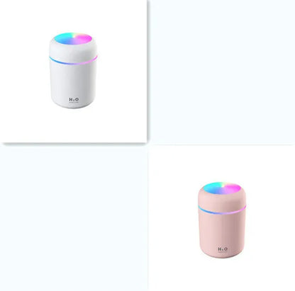 Pink car air purifying humidifier with LED lights on, next to a USB cable.