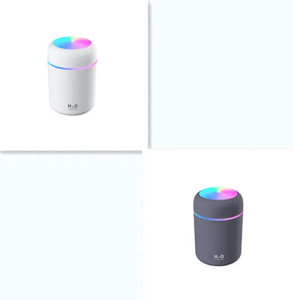 Pink car air purifying humidifier with LED lights on, next to a USB cable.