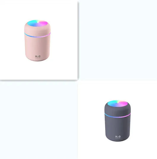 Pink car air purifying humidifier with LED lights on, next to a USB cable.