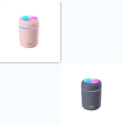 Pink car air purifying humidifier with LED lights on, next to a USB cable.