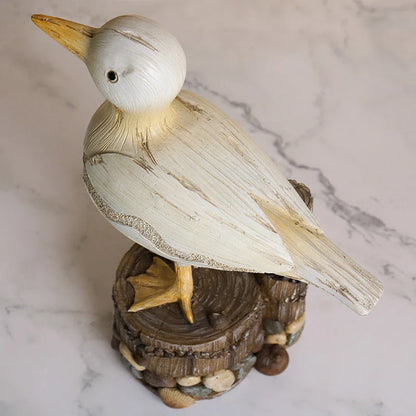 Realistic resin seagull statue with wooden stump base, perfect for coastal-inspired home decor